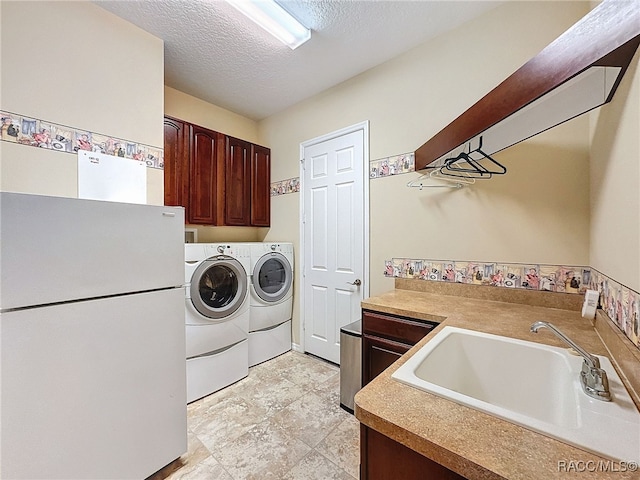 4339 N Canarywood Ter, Beverly Hills, FL 34465 - washroom featuring cabinets, washer and dryer, sink, and a textured ceiling