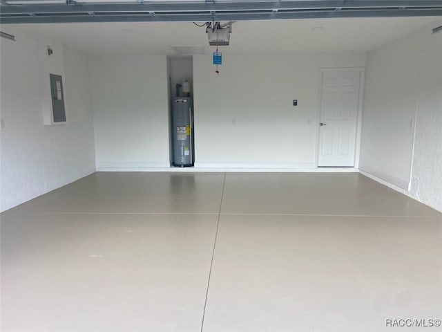 garage featuring a garage door opener, electric panel, and water heater