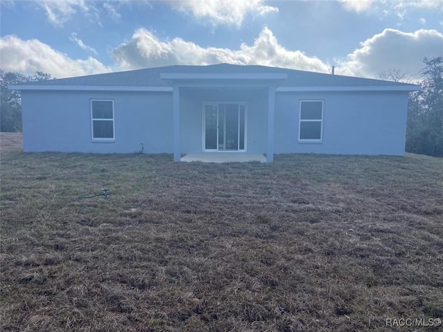 rear view of house with a lawn