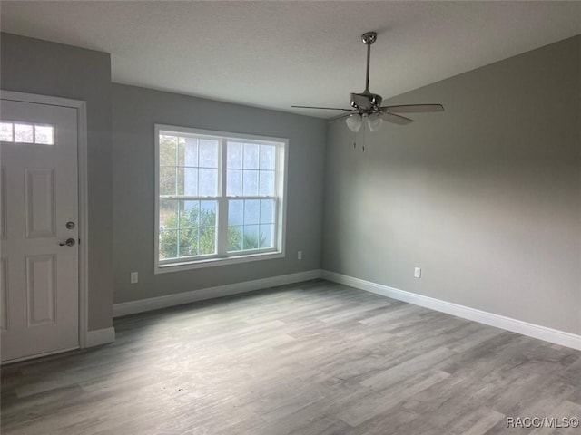 entrance foyer featuring ceiling fan and light wood-type flooring