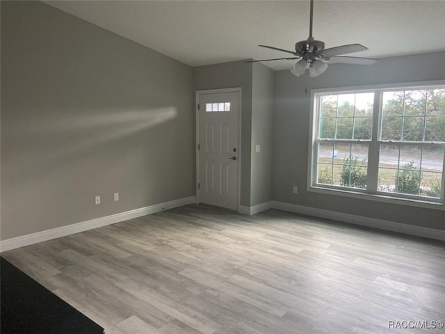 foyer entrance with ceiling fan, lofted ceiling, and light hardwood / wood-style floors