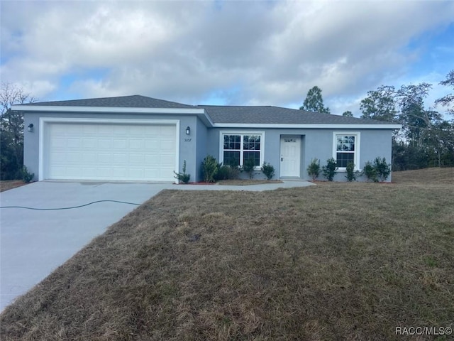 ranch-style house featuring a garage and a front lawn