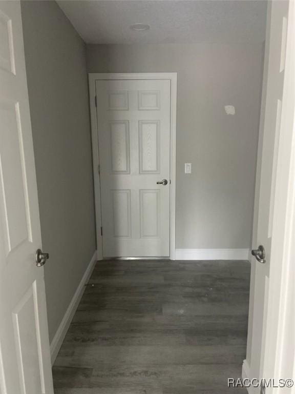 hallway with dark wood-type flooring