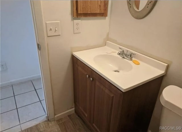 bathroom featuring toilet, vanity, and tile patterned floors