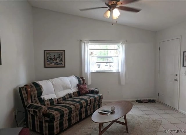 living room with ceiling fan, lofted ceiling, and light tile patterned floors