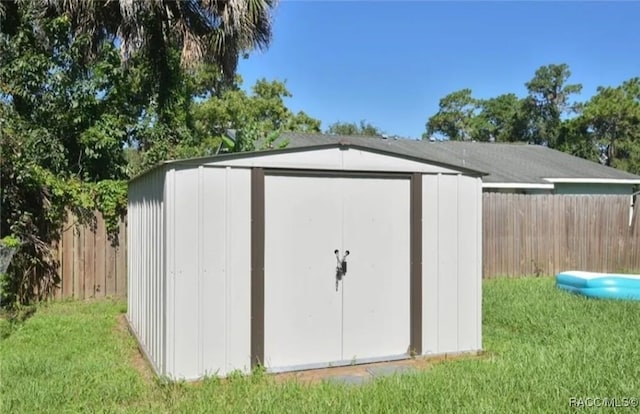 view of outdoor structure featuring a lawn