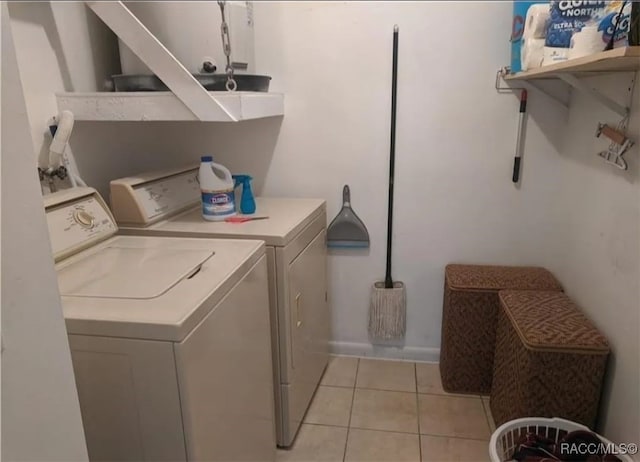 laundry area with light tile patterned floors and separate washer and dryer