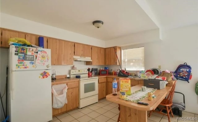 kitchen with light tile patterned floors and white appliances