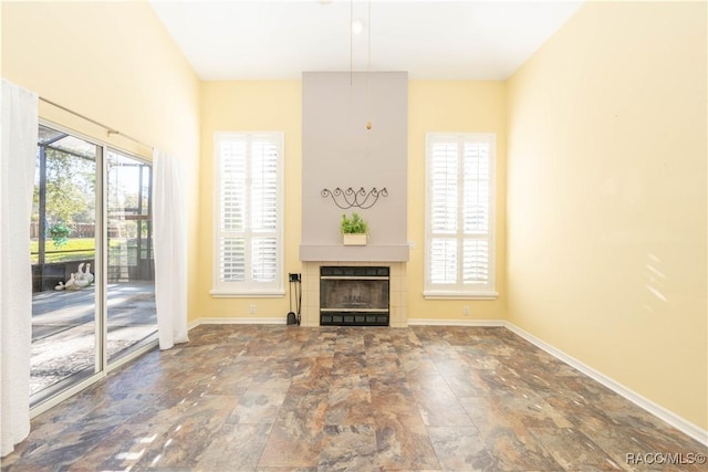 unfurnished living room with a tiled fireplace