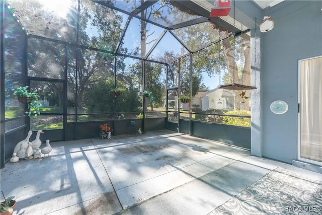 view of patio featuring glass enclosure