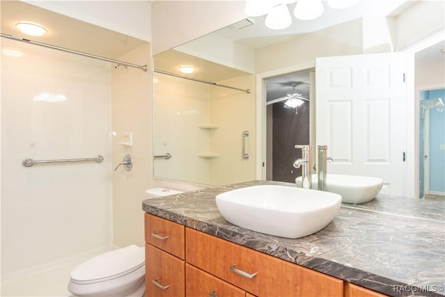 bathroom featuring walk in shower, ceiling fan, vanity, and toilet