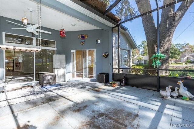 view of patio / terrace featuring ceiling fan and a lanai