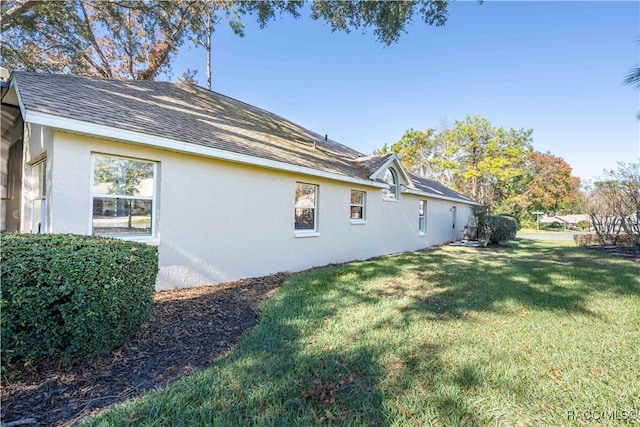 view of property exterior with a lawn