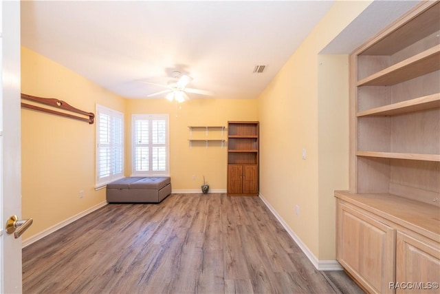 interior space featuring wood-type flooring and ceiling fan