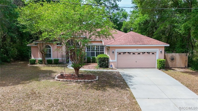 7690 N Greendale Dr, Citrus Springs, FL 34434 - view of front facade with stucco siding, an attached garage, driveway, and roof with shingles