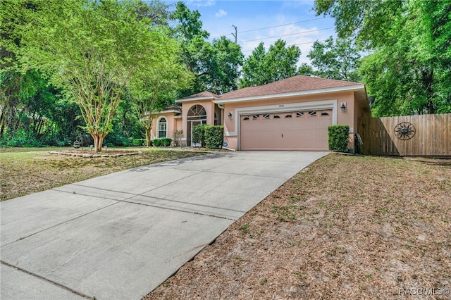7690 N Greendale Dr, Citrus Springs, FL 34434 - view of front facade with stucco siding, an attached garage, and driveway