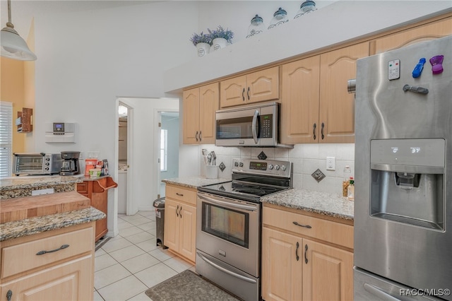 7690 N Greendale Dr, Citrus Springs, FL 34434 - kitchen featuring appliances with stainless steel finishes, light brown cabinets, light tile patterned floors, decorative backsplash, and light stone countertops
