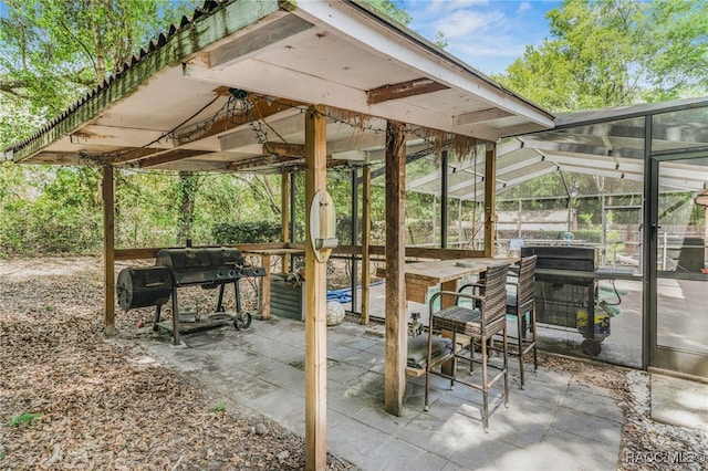 7690 N Greendale Dr, Citrus Springs, FL 34434 - view of patio / terrace featuring grilling area and glass enclosure