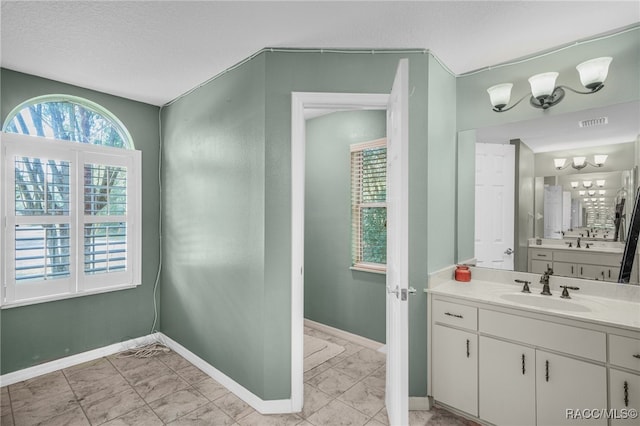 7690 N Greendale Dr, Citrus Springs, FL 34434 - bathroom featuring vanity, baseboards, and healthy amount of natural light