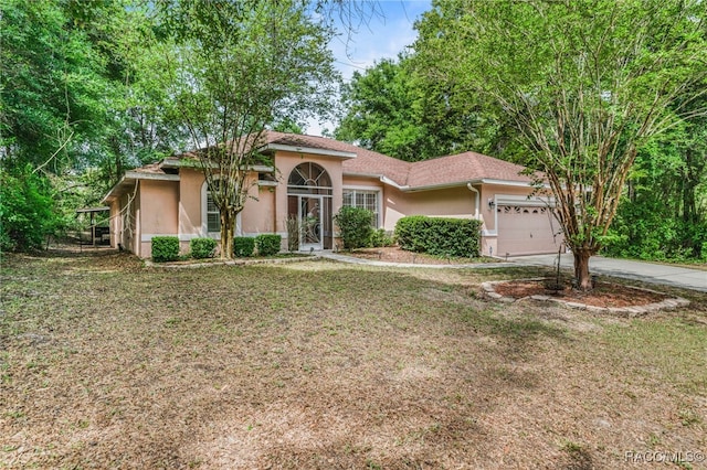 7690 N Greendale Dr, Citrus Springs, FL 34434 - view of front facade featuring stucco siding, a garage, concrete driveway, and a front lawn