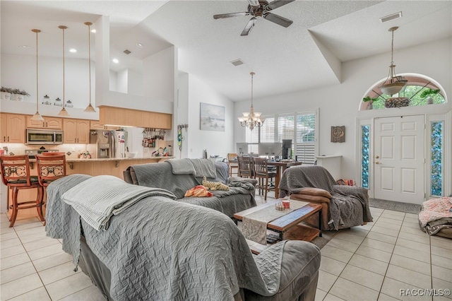 7690 N Greendale Dr, Citrus Springs, FL 34434 - living room with light tile patterned floors, a chandelier, high vaulted ceiling, and a ceiling fan