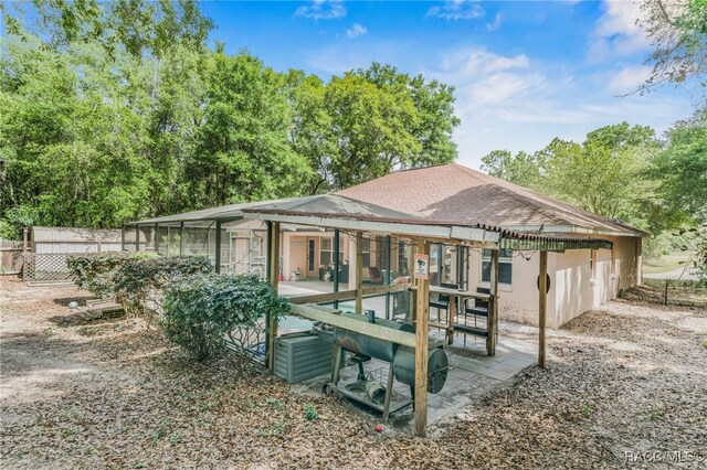 7690 N Greendale Dr, Citrus Springs, FL 34434 - back of house with a patio area and roof with shingles