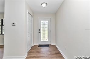 doorway with hardwood / wood-style floors