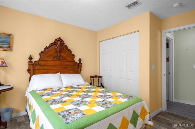 bedroom with hardwood / wood-style floors and a closet