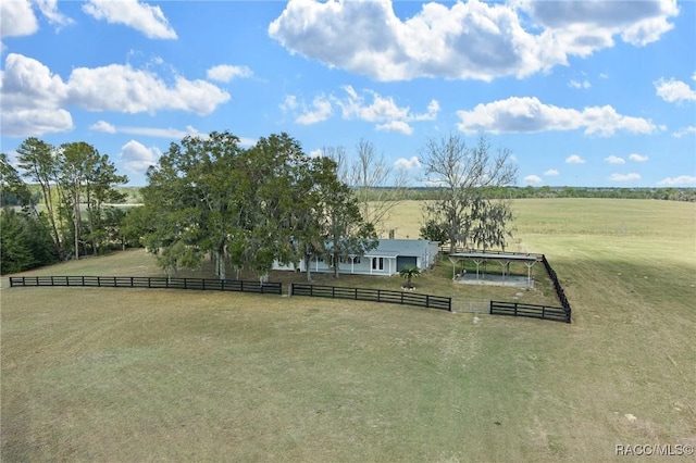 view of yard featuring fence and a rural view