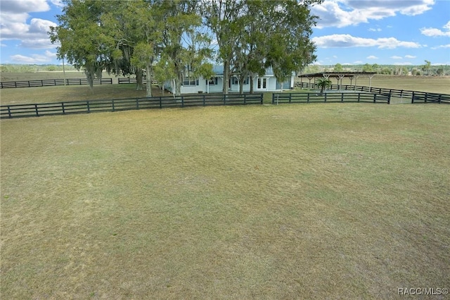 view of yard with a rural view