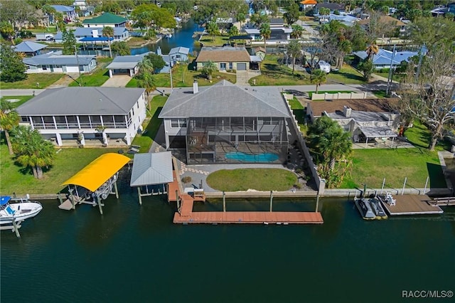 drone / aerial view featuring a water view and a residential view