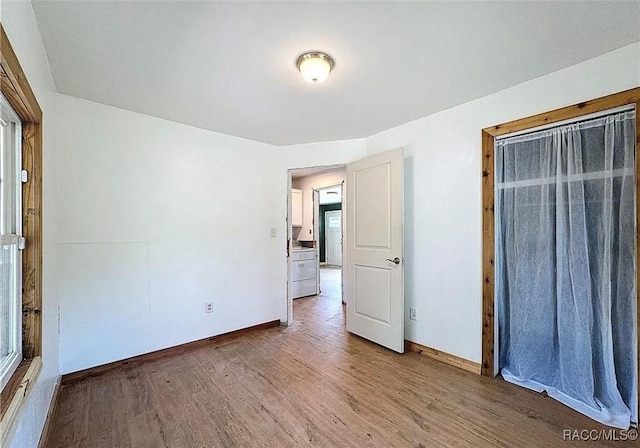 unfurnished bedroom with hardwood / wood-style floors