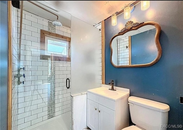 bathroom with vanity, an enclosed shower, and toilet