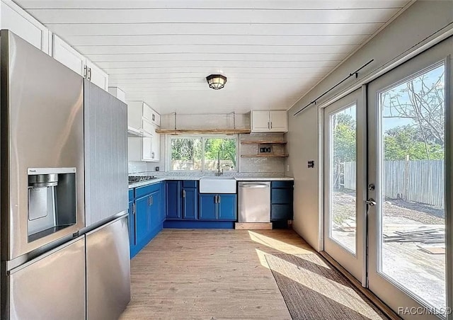 kitchen featuring sink, blue cabinetry, stainless steel appliances, white cabinets, and french doors