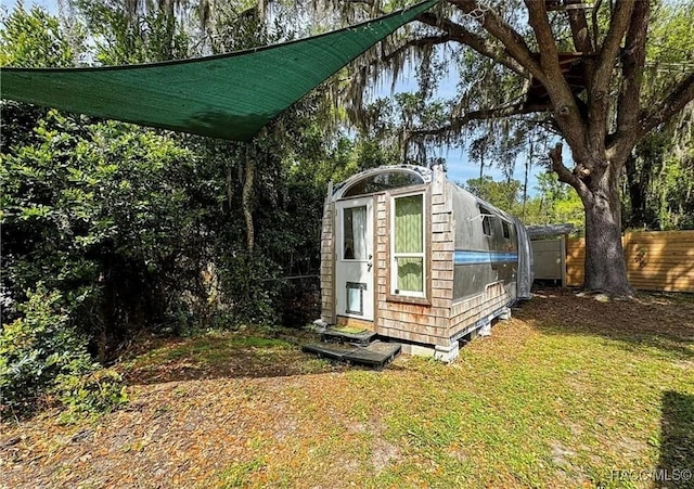 view of outdoor structure with a lawn