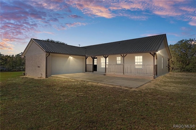 view of front of property with a yard and a garage