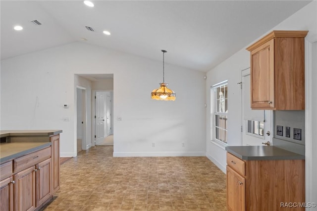 kitchen featuring lofted ceiling and hanging light fixtures