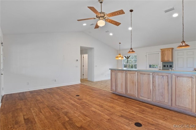 kitchen featuring lofted ceiling, light brown cabinetry, ceiling fan, and light hardwood / wood-style flooring