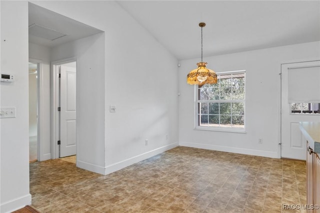 unfurnished dining area with a chandelier and vaulted ceiling