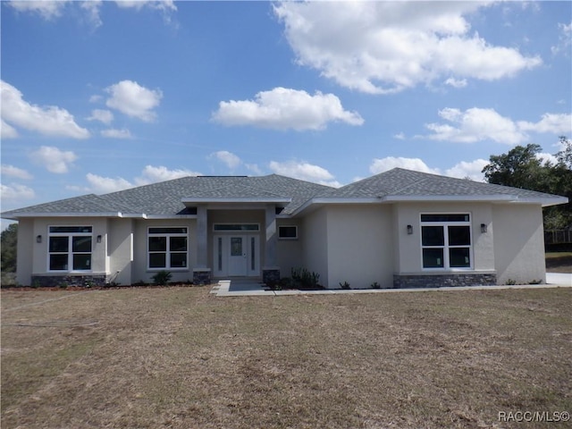 prairie-style home featuring a front lawn