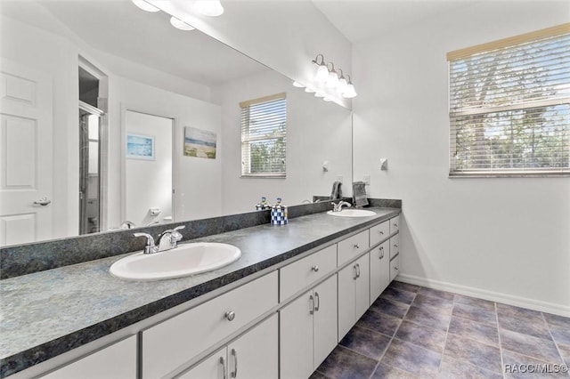 4340 W Mustang Blvd, Beverly Hills, FL 34465 - bathroom with double vanity, baseboards, and a stall shower