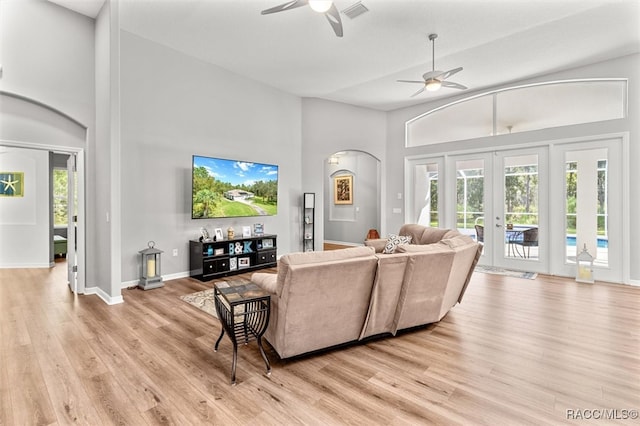 living room with french doors, high vaulted ceiling, light hardwood / wood-style flooring, and ceiling fan