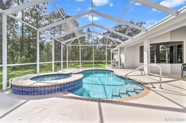 view of swimming pool with a patio area, a lanai, and an in ground hot tub