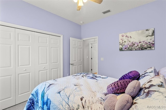 carpeted bedroom with a closet and ceiling fan