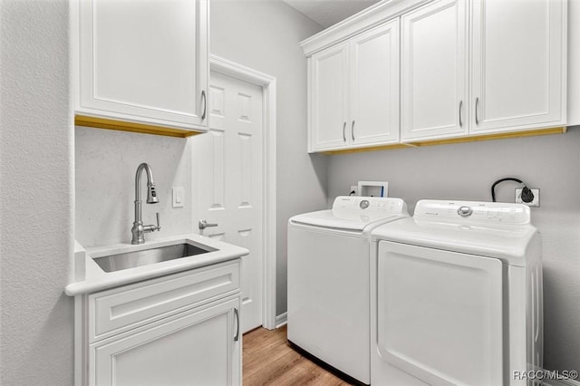 4340 W Mustang Blvd, Beverly Hills, FL 34465 - washroom with cabinet space, washer and dryer, and light wood-style flooring