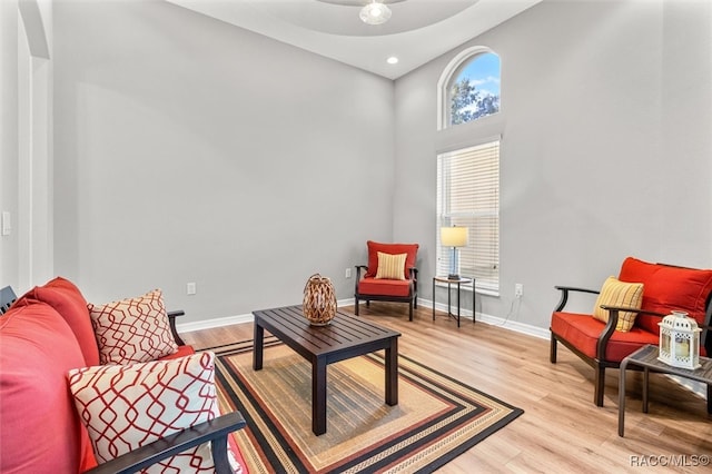 living area with ceiling fan and light hardwood / wood-style flooring