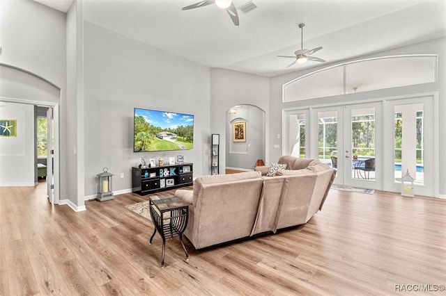 4340 W Mustang Blvd, Beverly Hills, FL 34465 - living area with arched walkways, a ceiling fan, light wood finished floors, healthy amount of natural light, and high vaulted ceiling
