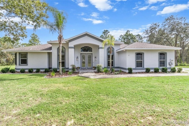 view of front of home featuring a front yard and french doors