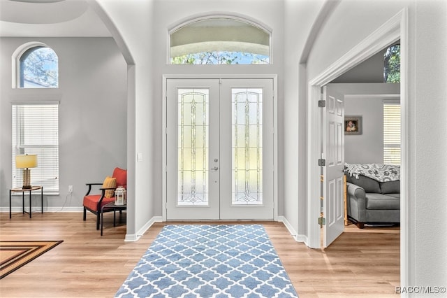 entryway featuring french doors and light hardwood / wood-style flooring