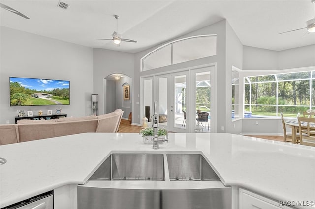 kitchen with wood-type flooring, ceiling fan, french doors, and sink